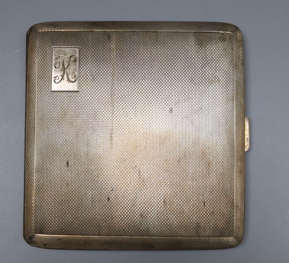 Three assorted mid 20th century silver engine turned cigarette cases, largest 16.8cm, gross 18oz.